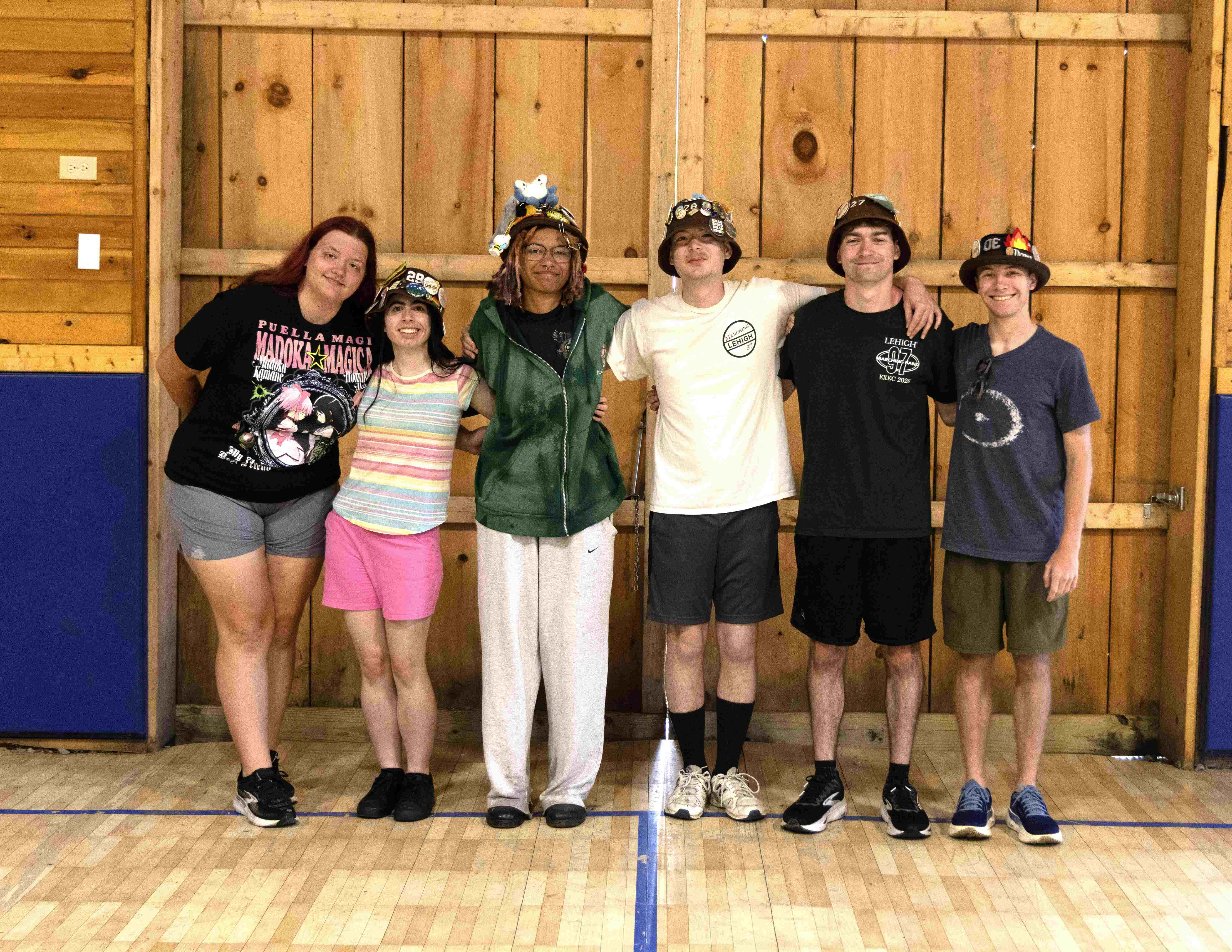 Rank 1 smiling with their arms around each other at band camp.
