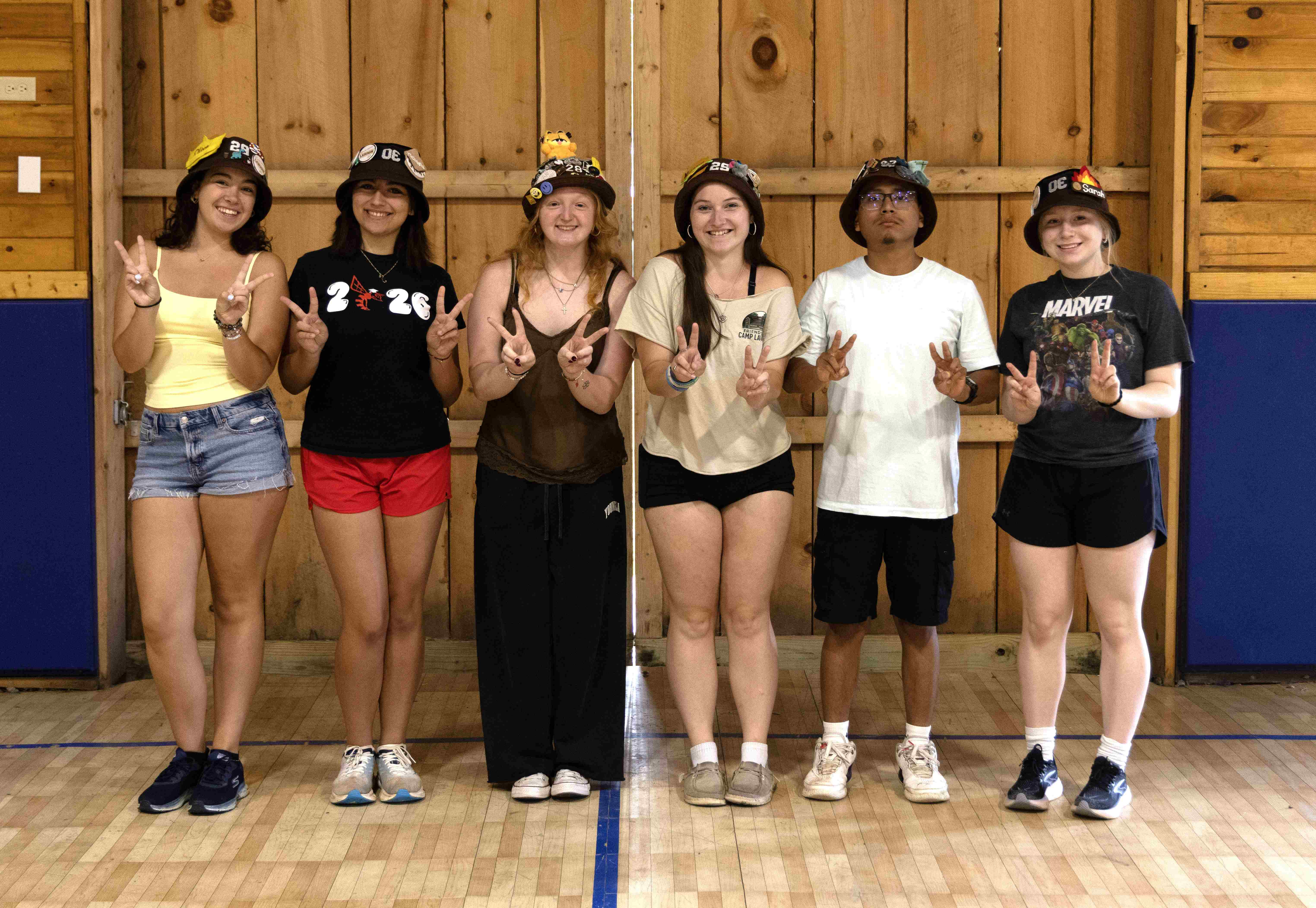 Rank 2 smiling, holding up two fingers on each hand.