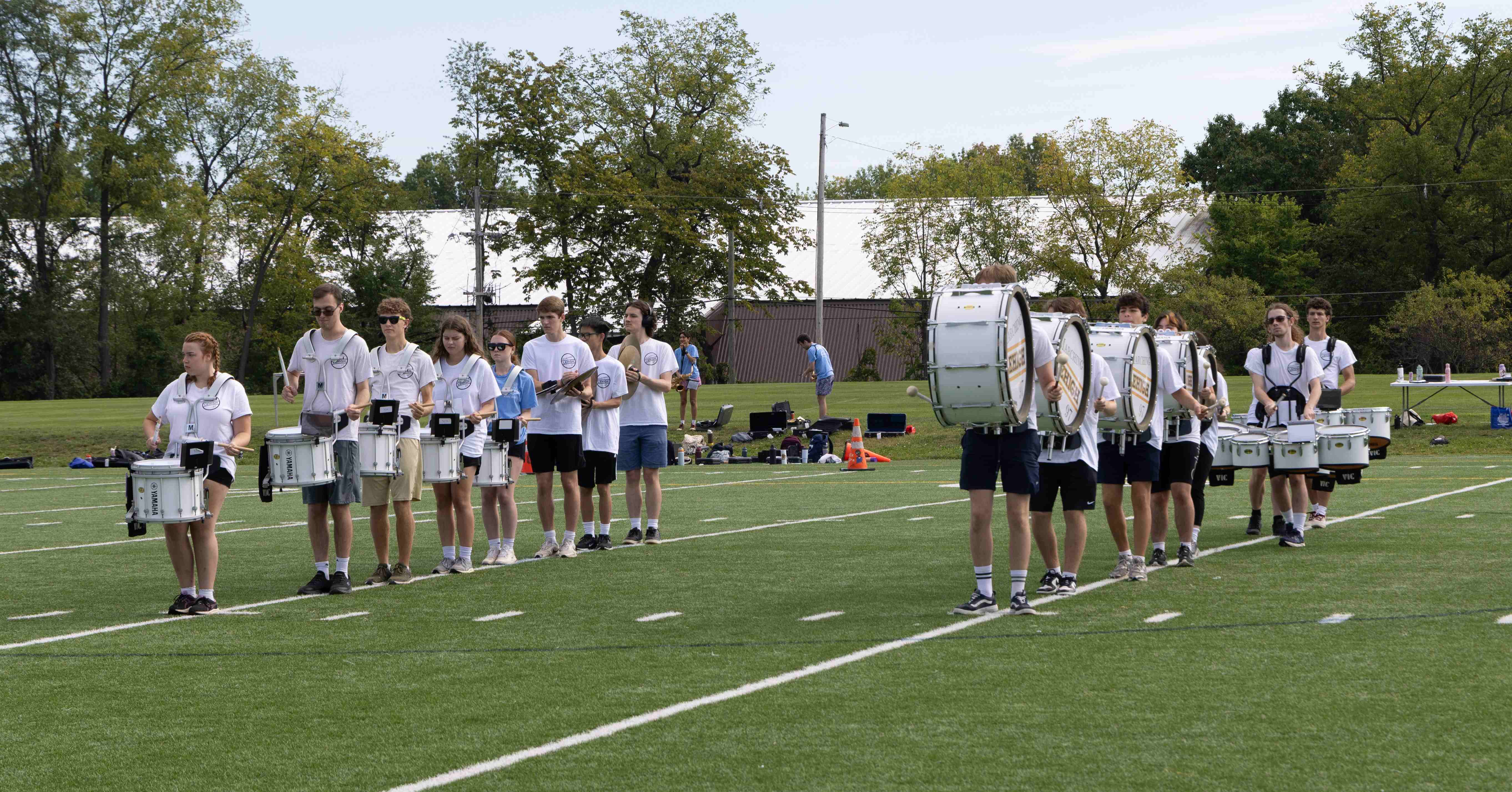Ranks 3 and 12 standing on two yardlines on the practice field.