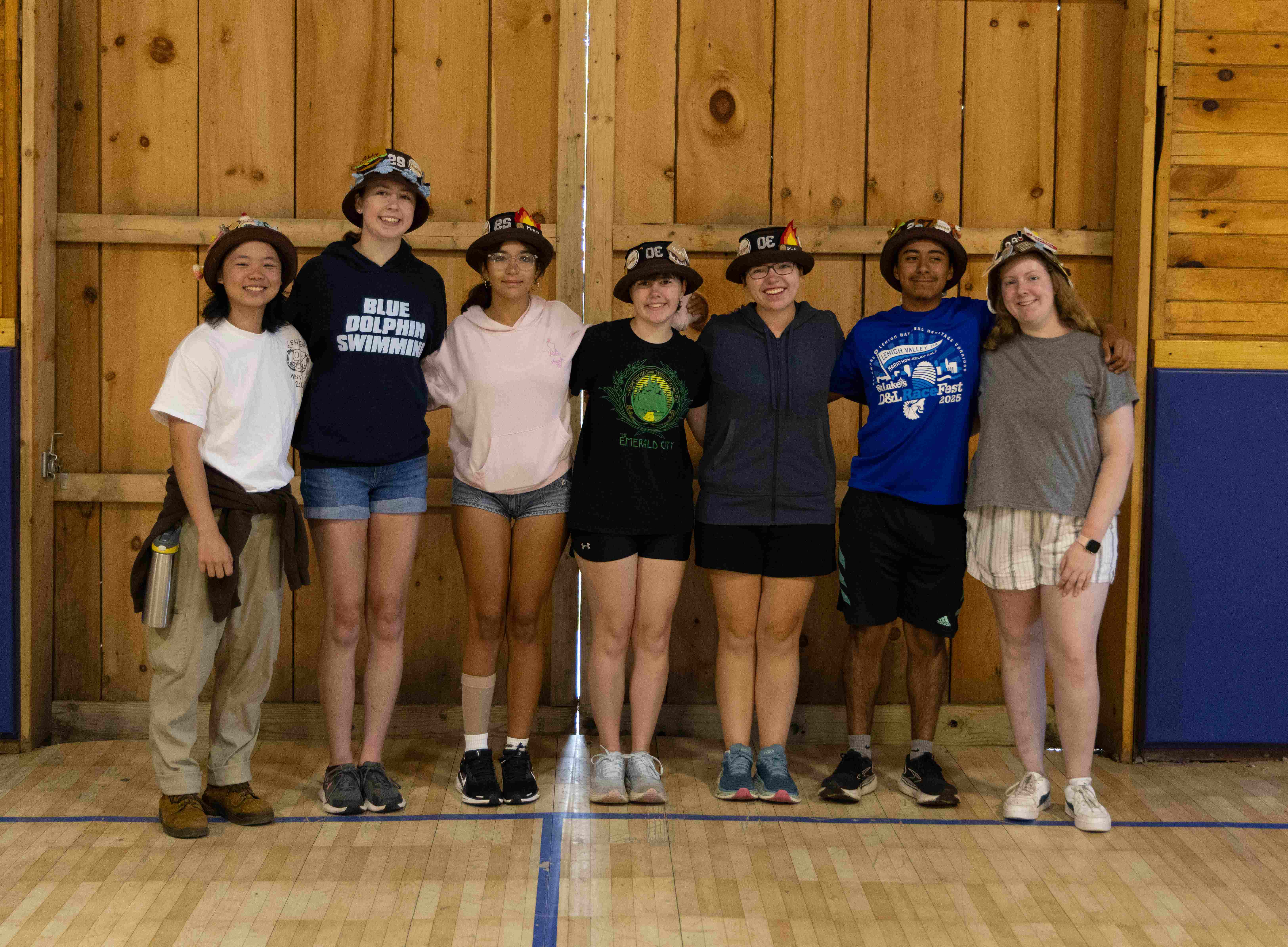 Rank 4 smiling with their arms around each other at band camp.
