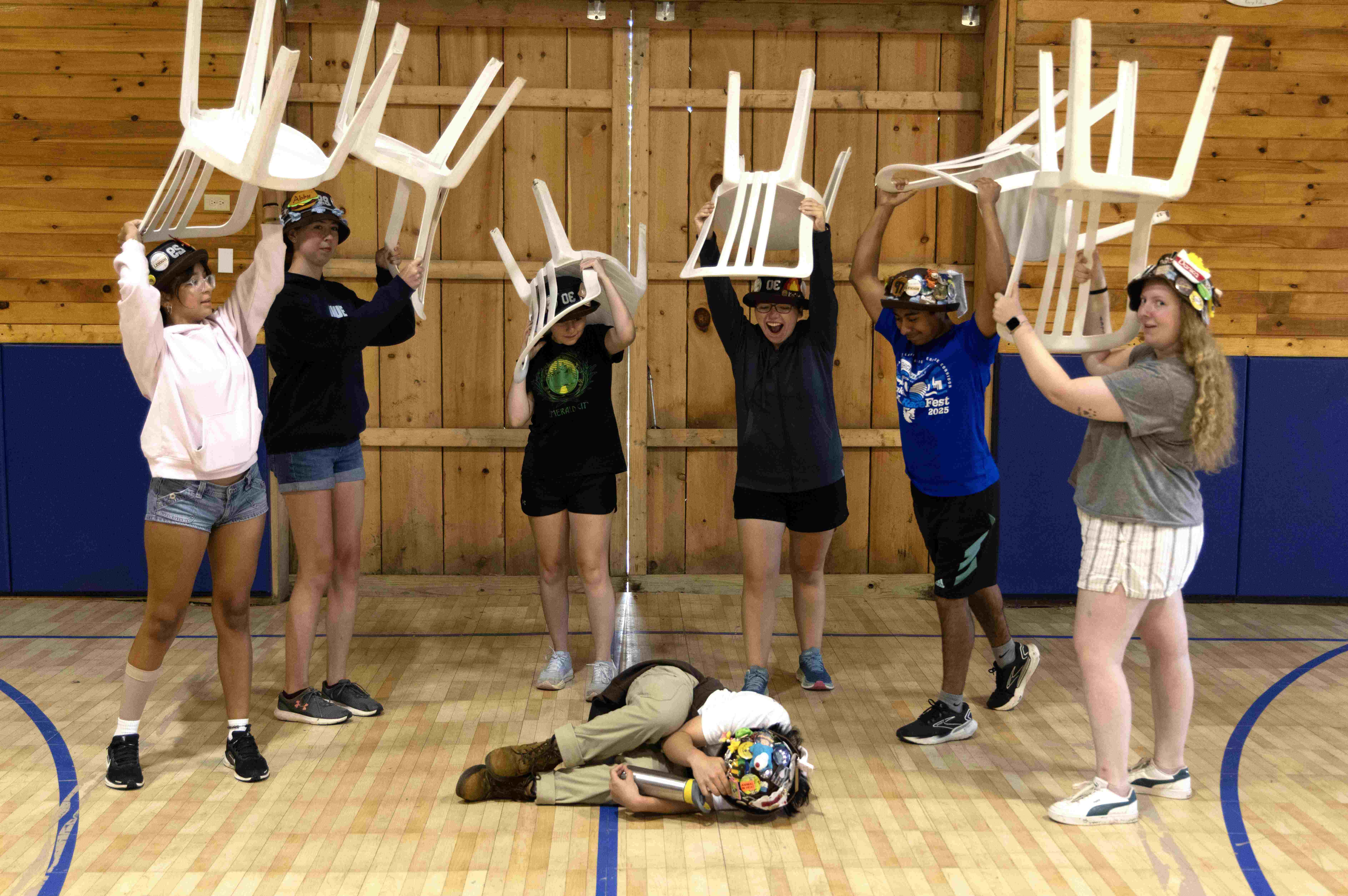 Rank 4 pretending to beat up one of their members with chairs.
