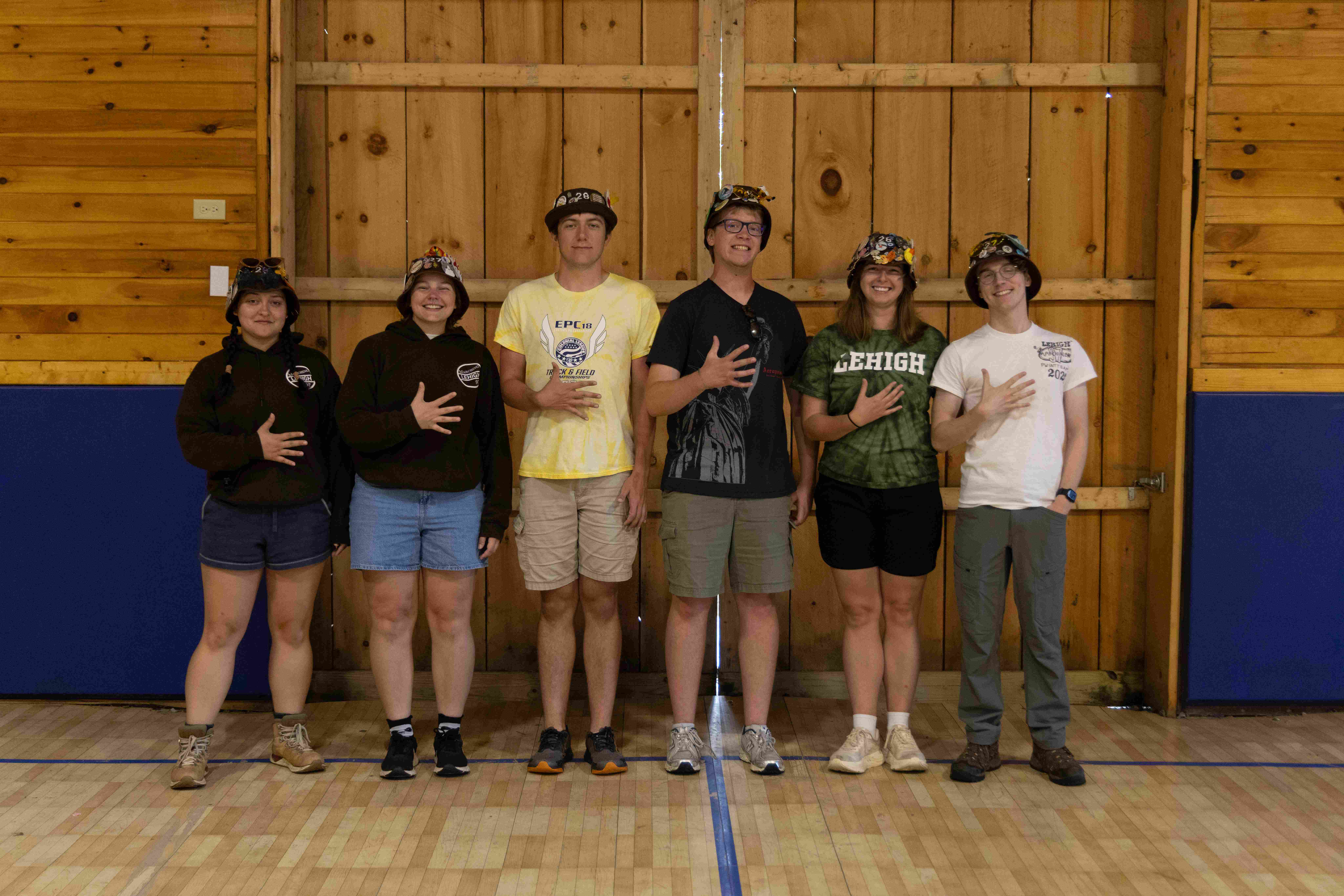 Rank 5 smiling, holding up five fingers on one hand.