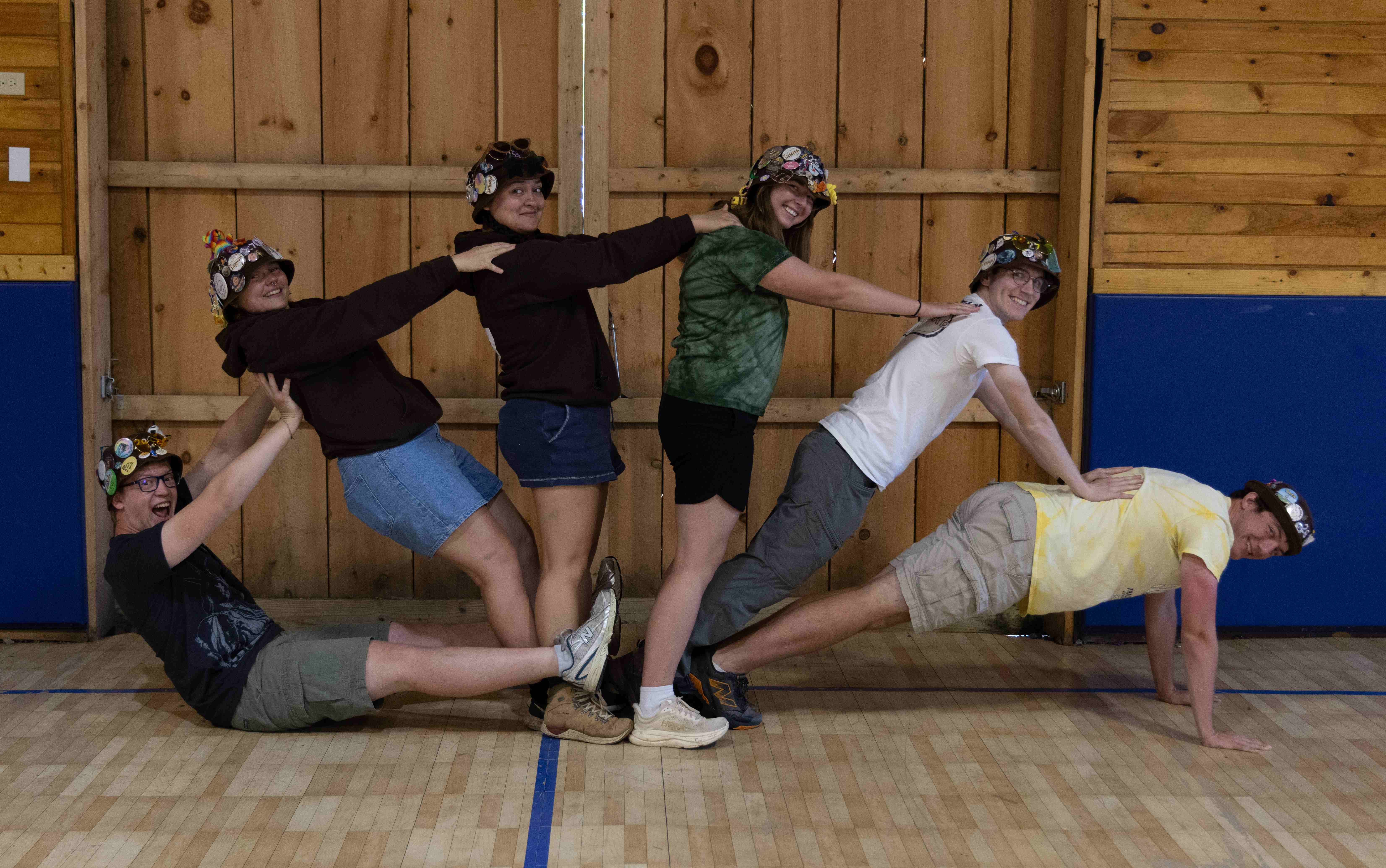 Rank 5 forming an arc by leaning on each other.