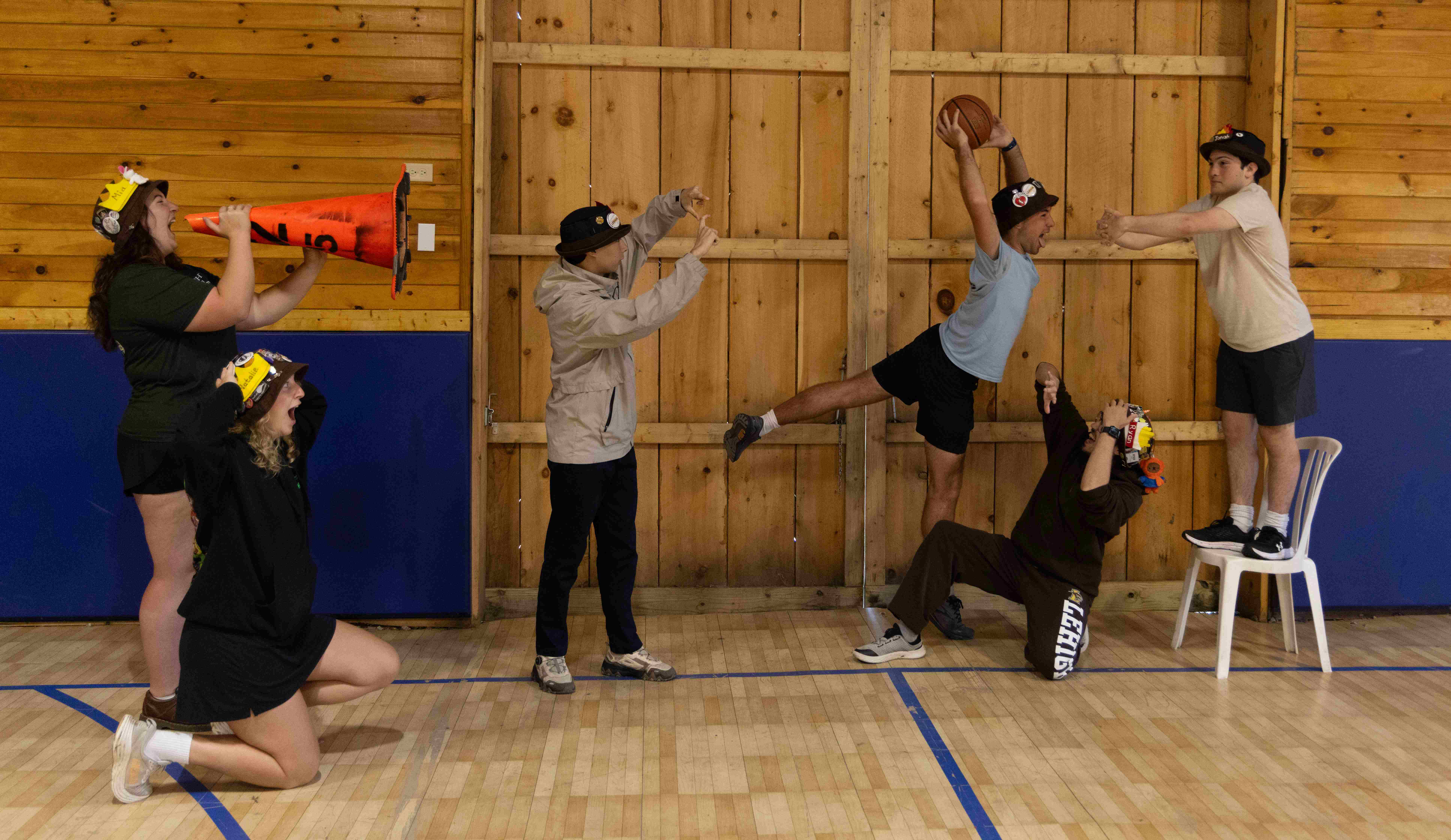 Rank 7 pretending to play basketball, with one of their members dunking on another.